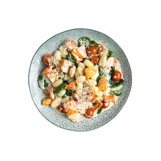Gnocchi in salmon cream sauce with spinach and tomatoes