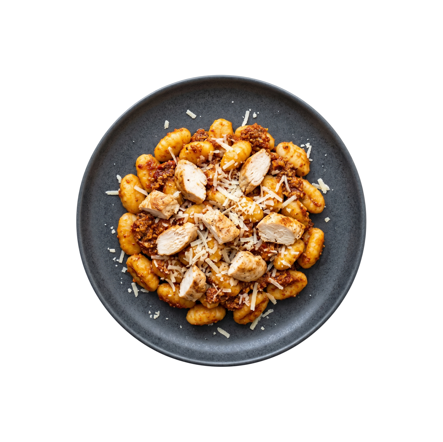 Gnocchi in red pesto with chicken breast and Parmesan