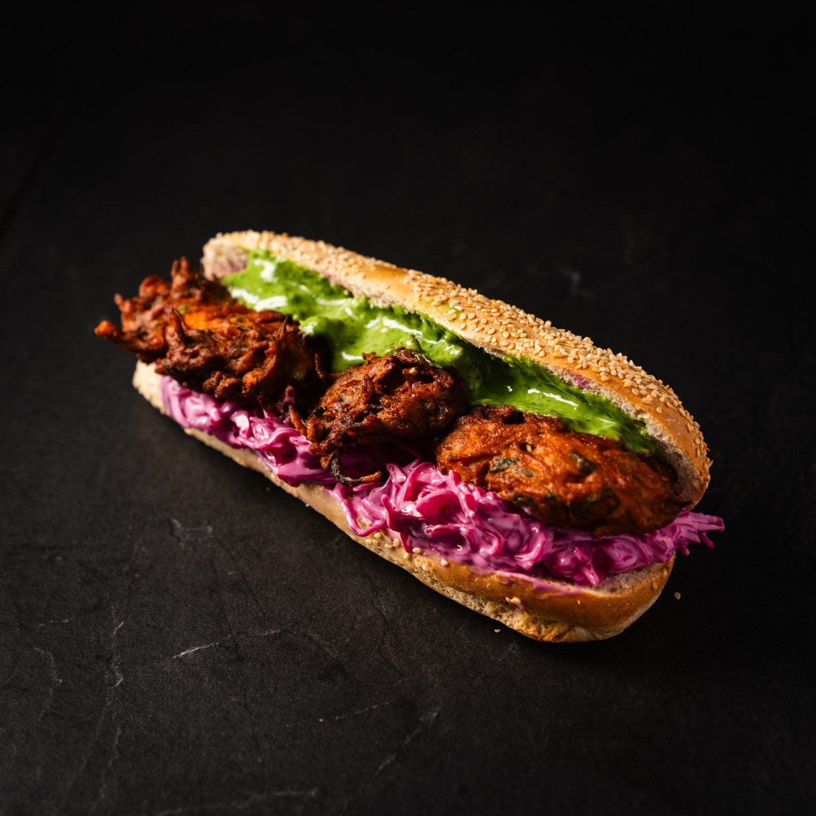 Sandwich mit Gemüse-Pakora, Rotkohl-Slaw und grüner Kräutersauce